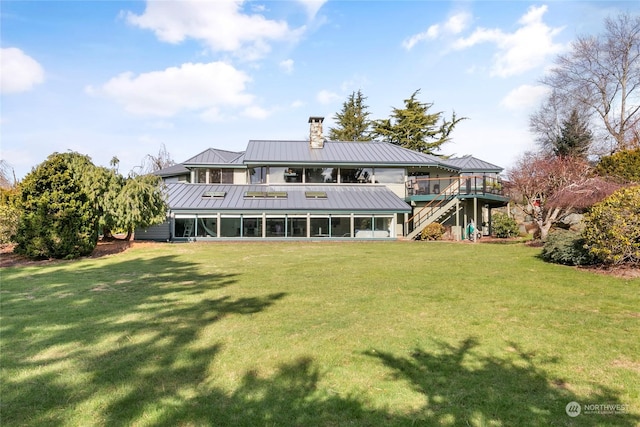 back of house with a yard and a deck