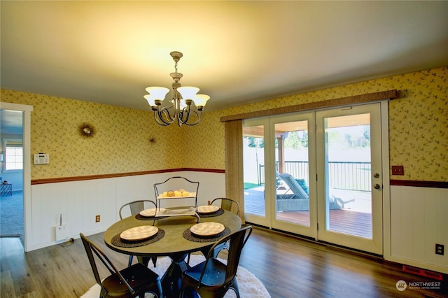 dining space featuring an inviting chandelier, a healthy amount of sunlight, and wood-type flooring