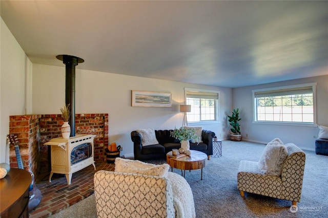 living room featuring carpet floors and a wood stove