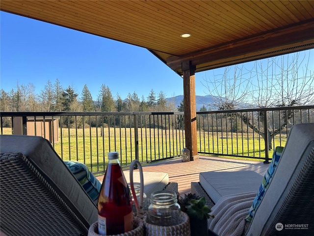 deck featuring a yard and grilling area