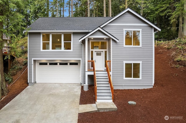 split foyer home with driveway and a shingled roof