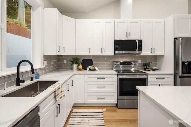 kitchen with sink, stainless steel appliances, and white cabinets