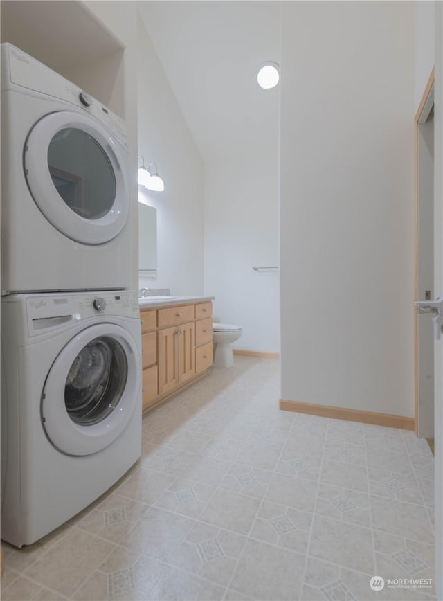 laundry room with stacked washer / dryer and sink