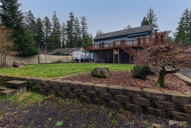 rear view of property with a lawn and a deck