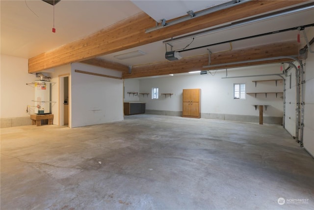 garage featuring a garage door opener and strapped water heater