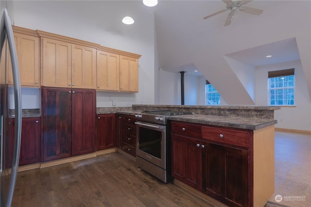 kitchen with light brown cabinetry, dark hardwood / wood-style floors, kitchen peninsula, ceiling fan, and stainless steel appliances