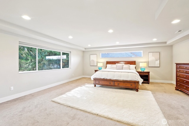 bedroom featuring baseboards, light colored carpet, a raised ceiling, and recessed lighting