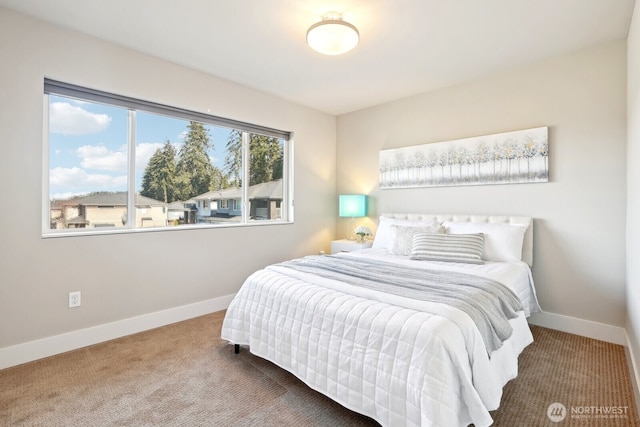 carpeted bedroom featuring baseboards