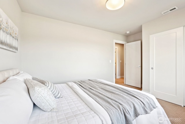 bedroom with light colored carpet and visible vents