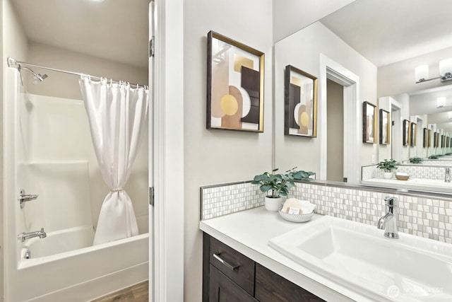 full bathroom featuring shower / tub combo with curtain, backsplash, and vanity