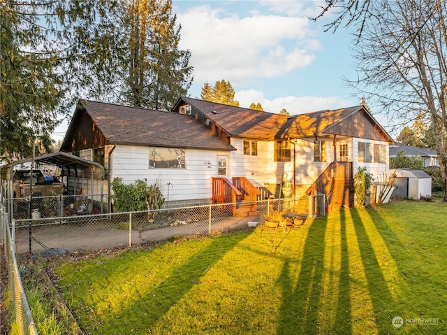 rear view of property featuring a yard, a carport, and a storage unit