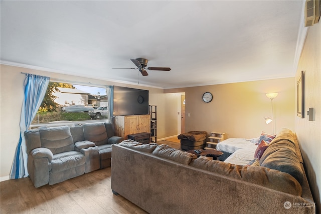 living room featuring crown molding, ceiling fan, and wood-type flooring