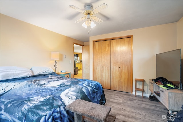 bedroom with ceiling fan, light wood-type flooring, and a closet