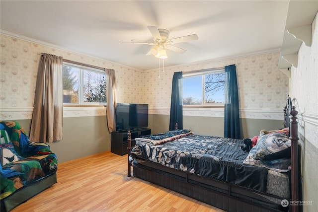 bedroom with ornamental molding, hardwood / wood-style floors, and ceiling fan