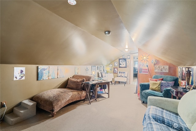 living area featuring lofted ceiling and carpet