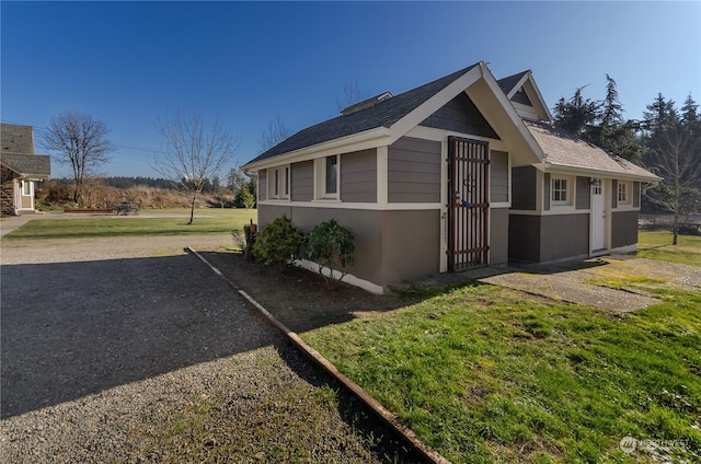 view of property exterior featuring a lawn