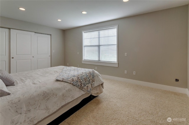 bedroom featuring carpet and a closet