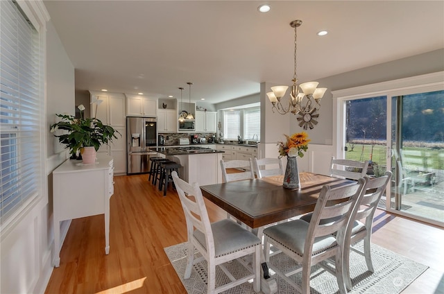 dining room with a chandelier and light hardwood / wood-style floors