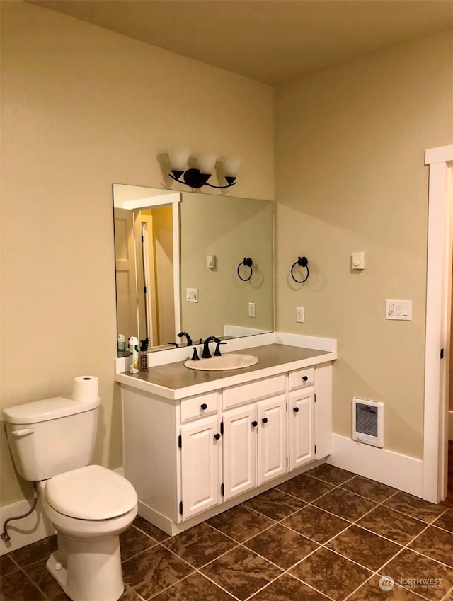 bathroom with tile patterned flooring, vanity, and toilet