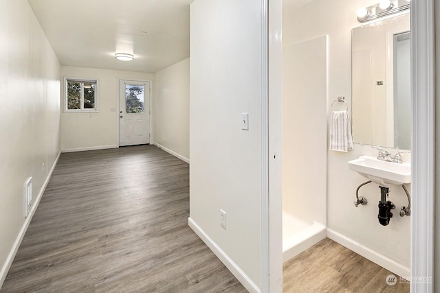 foyer entrance featuring sink and hardwood / wood-style flooring