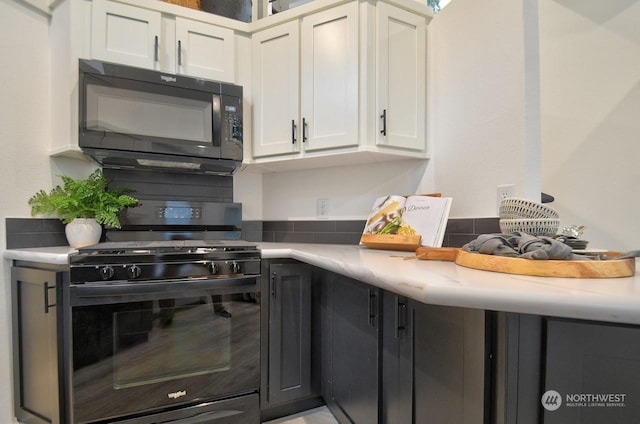 kitchen with black appliances and white cabinets