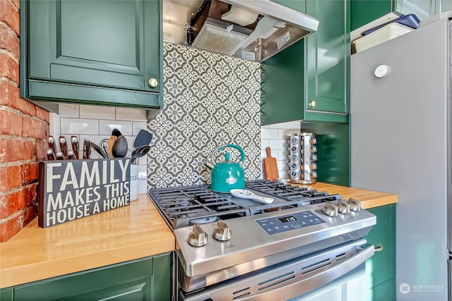 kitchen with ventilation hood, appliances with stainless steel finishes, and green cabinetry