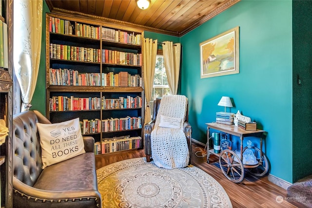 living area featuring crown molding, hardwood / wood-style floors, and wood ceiling