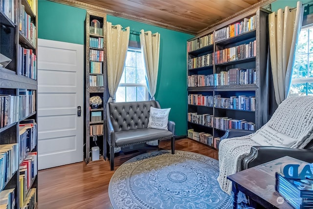 living area with hardwood / wood-style flooring, plenty of natural light, and wooden ceiling