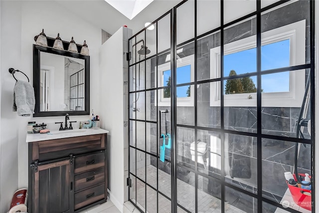 bathroom featuring vanity and tiled shower