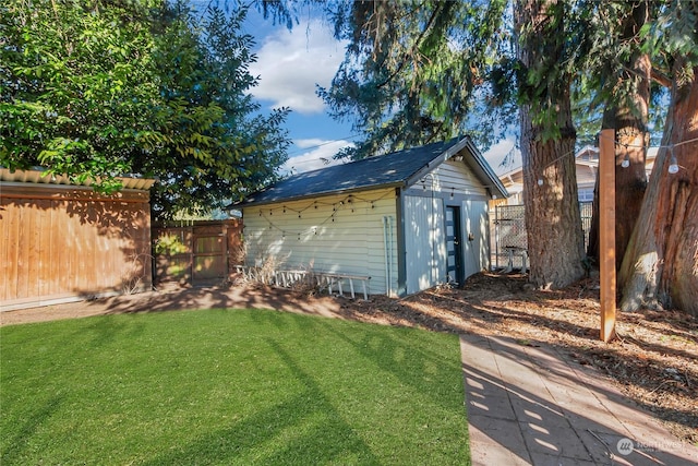 view of outbuilding with a lawn