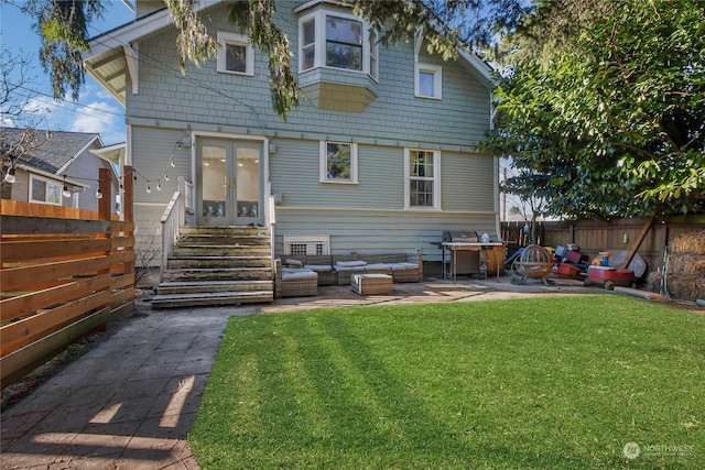 back of property with an outdoor living space, a patio area, french doors, and a lawn