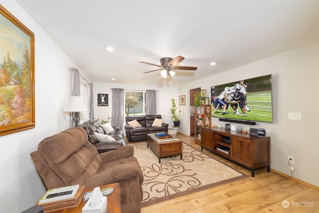 living room featuring light hardwood / wood-style flooring and ceiling fan