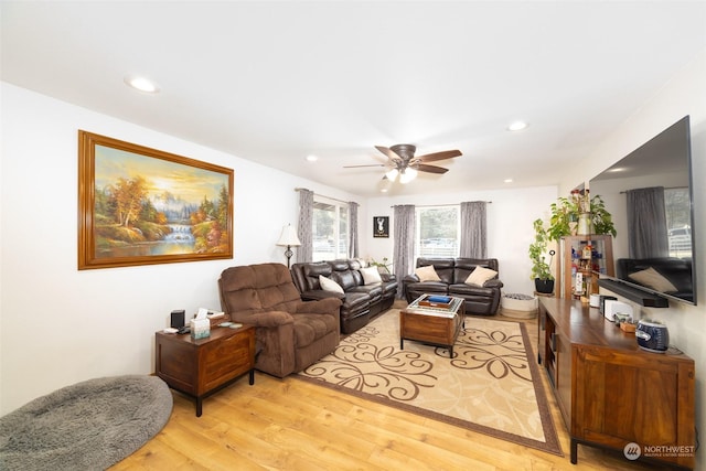 living room featuring ceiling fan and light wood-type flooring