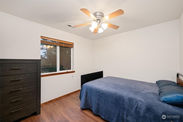 bedroom featuring hardwood / wood-style floors and ceiling fan