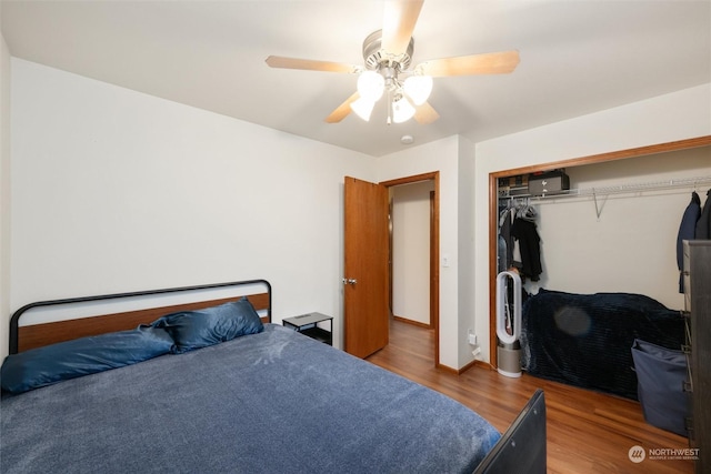 bedroom with hardwood / wood-style floors, ceiling fan, and a closet