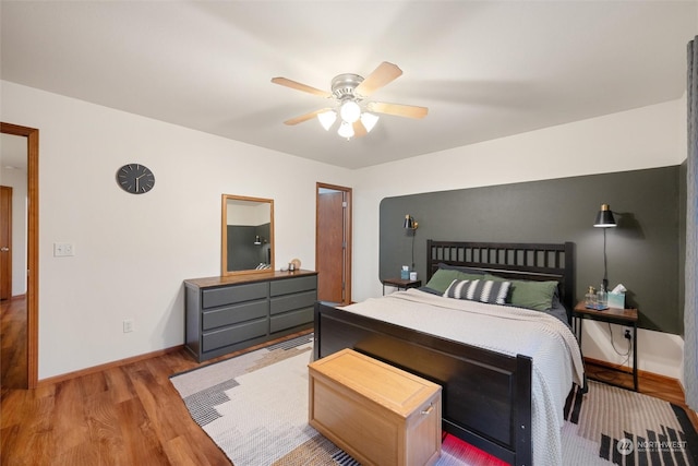 bedroom with hardwood / wood-style flooring and ceiling fan