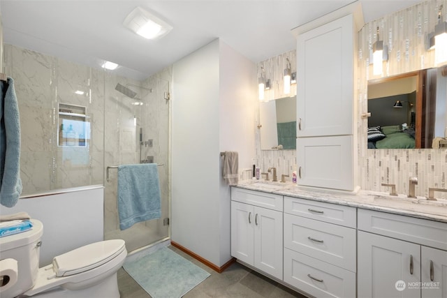 bathroom with vanity, toilet, an enclosed shower, and backsplash