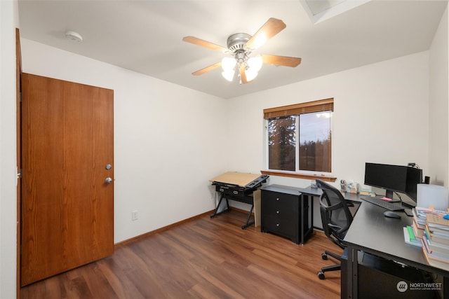 home office with dark hardwood / wood-style floors and ceiling fan