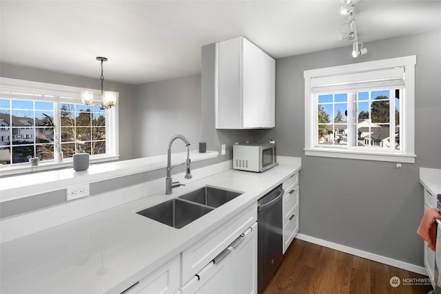 kitchen featuring white cabinetry, sink, a wealth of natural light, and appliances with stainless steel finishes