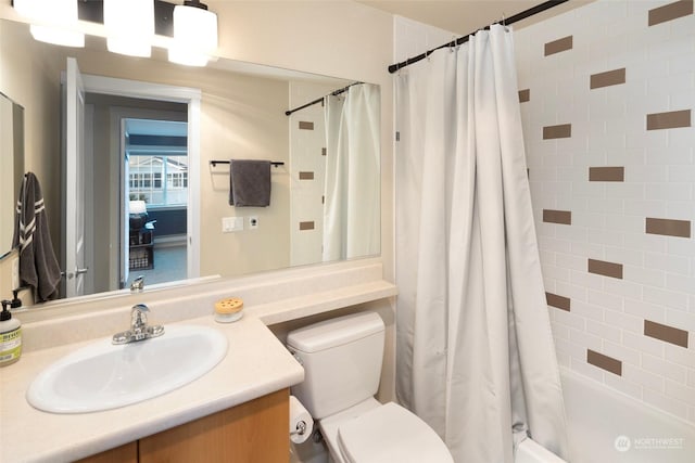 full bathroom with vanity, toilet, and shower / bath combo with shower curtain