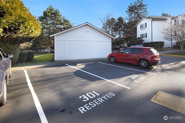 view of car parking featuring a garage