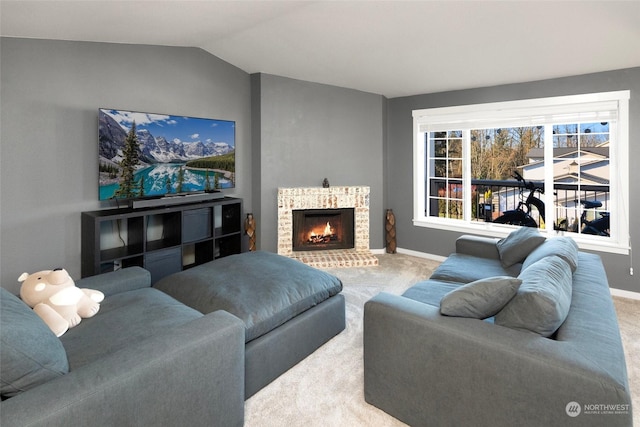 carpeted living room featuring lofted ceiling and a brick fireplace