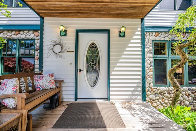 view of exterior entry featuring covered porch