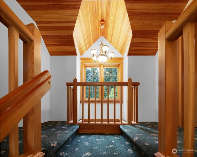 stairway featuring lofted ceiling, a notable chandelier, carpet floors, and wooden ceiling