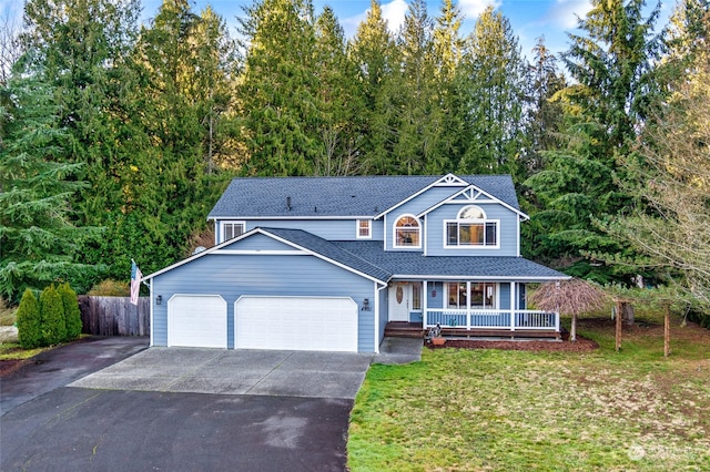 view of front of home featuring a porch, a garage, and a front lawn