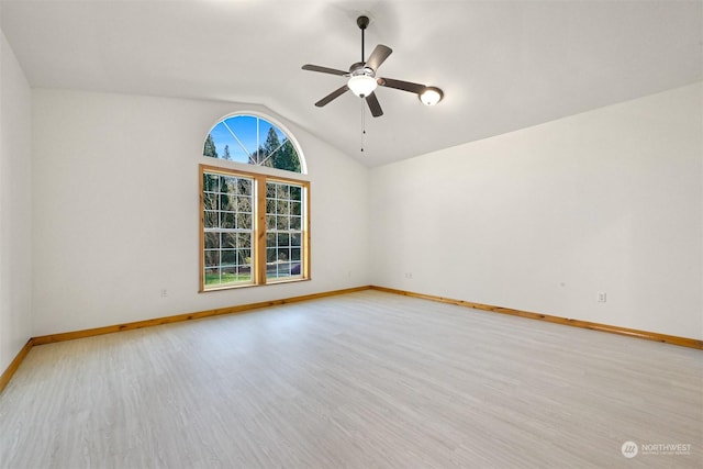 spare room featuring vaulted ceiling, ceiling fan, and light wood-type flooring