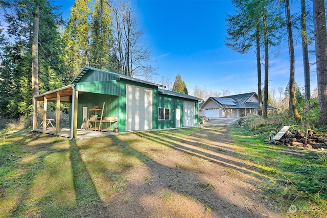 exterior space with a garage and a lawn