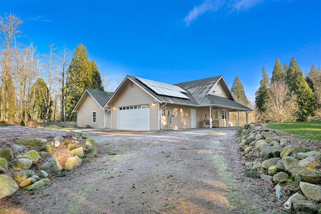 view of home's exterior featuring a garage and solar panels