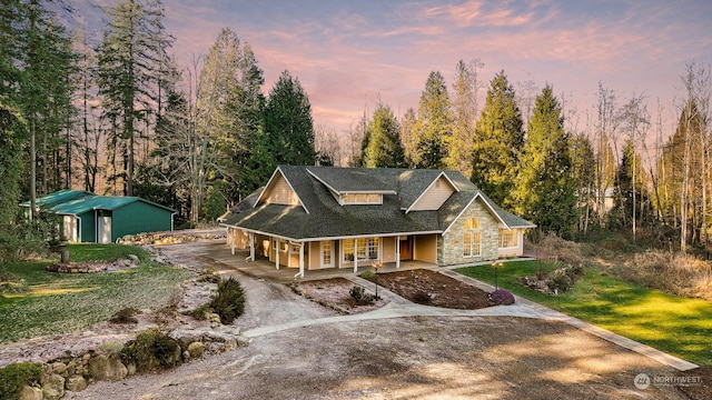 view of front of house featuring a porch and a yard