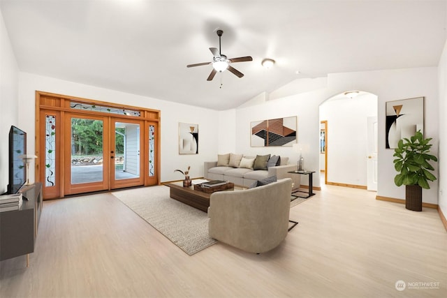 living room featuring french doors, vaulted ceiling, ceiling fan, and light hardwood / wood-style flooring